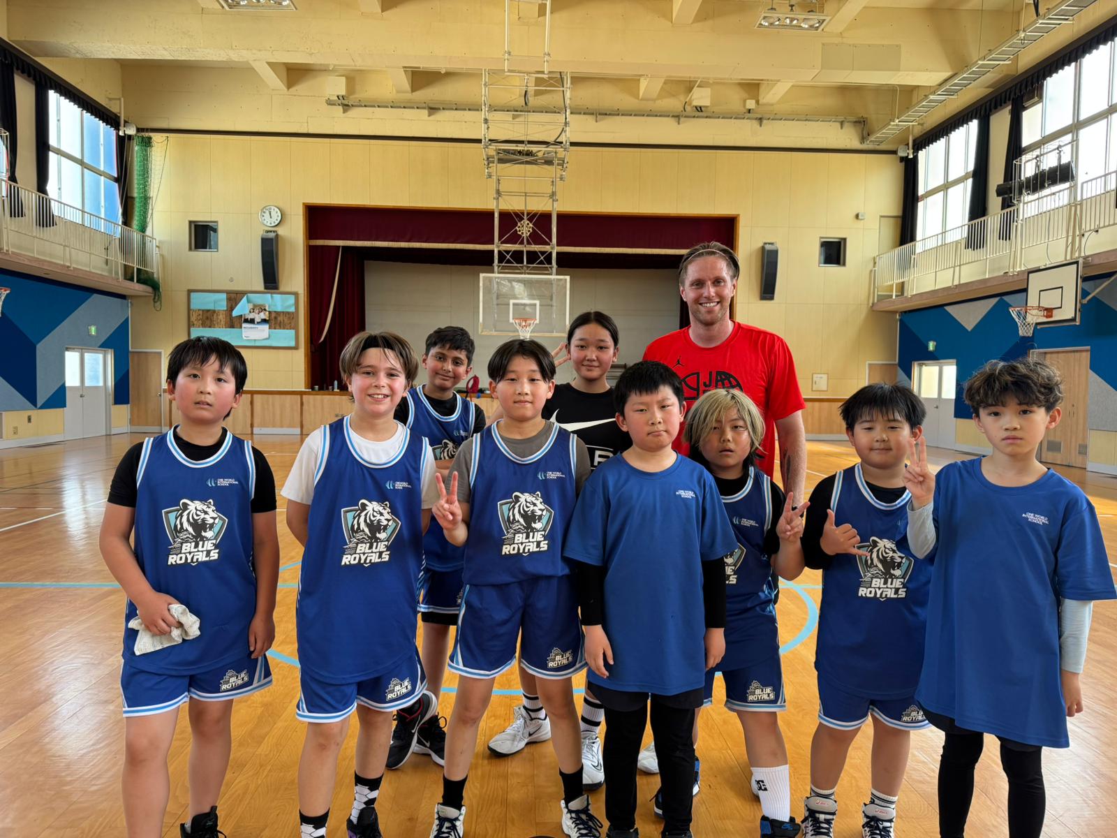 OWIS Osaka Blue Royals Basketball competative sports team, standing in newly renovated gymnasium, with professional sports coach